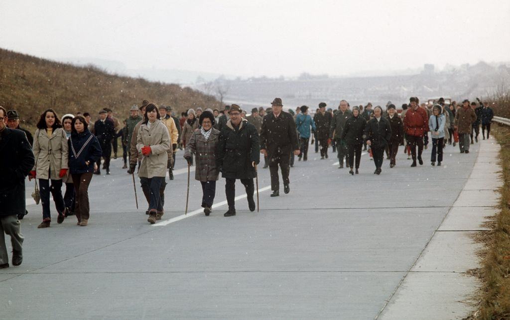 The Swabian Alpine Club wanders across a new part of the motorway Weinsberg-Moeckmuehl on the 9th of December in 1973.
