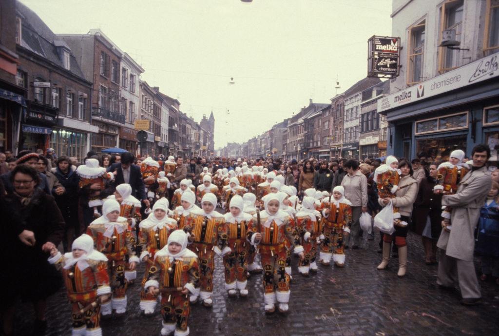 Gilles parade wearing their wax mask during the Binche carnival, Belgium, 1980s.
