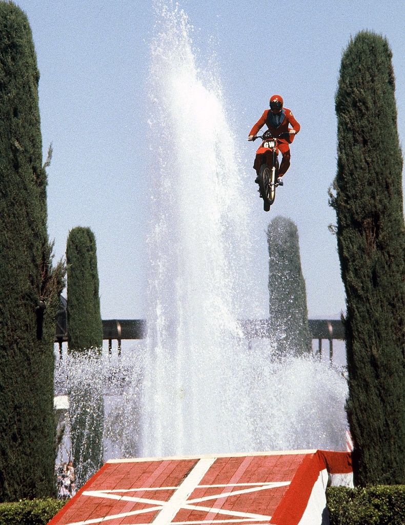 American stunt driver Gary Wells jumps over the fountains outside the Caesar's Palace casino on a motorcycle, Las Vegas, 1980.