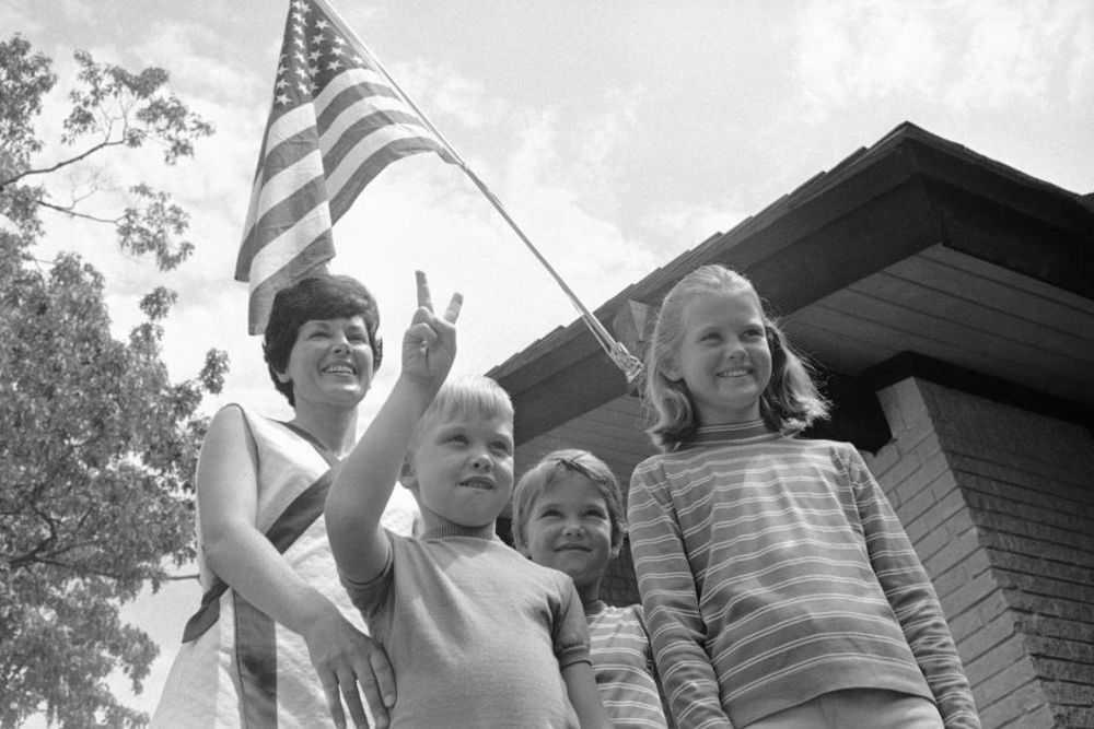 Pat Collins (left) stands with the couple’s three children—Mike, 6; Ann, 7; and Kathleen, 10—on the lawn of their family home in Houston, Texas.