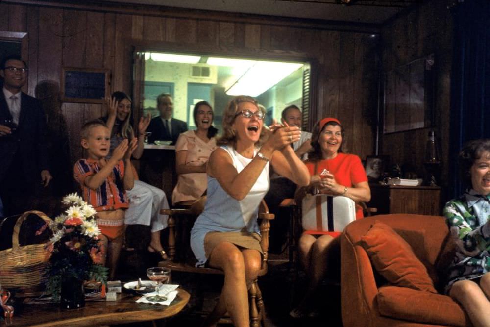 Surrounded by friends and family, Joan Aldrin (center) claps for her husband, Apollo 11 astronaut Buzz Aldrin.