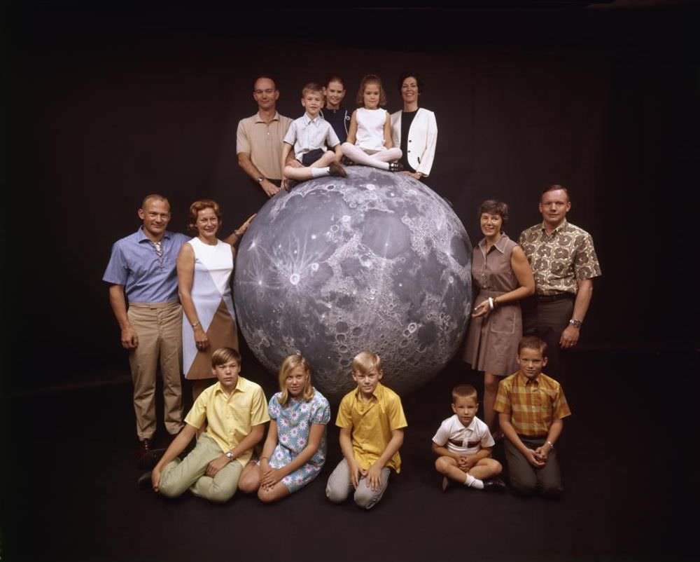 The three Apollo 11 astronauts pose with their families on a model of the moon in March 1969, ahead of the mission’s July 16 launch.