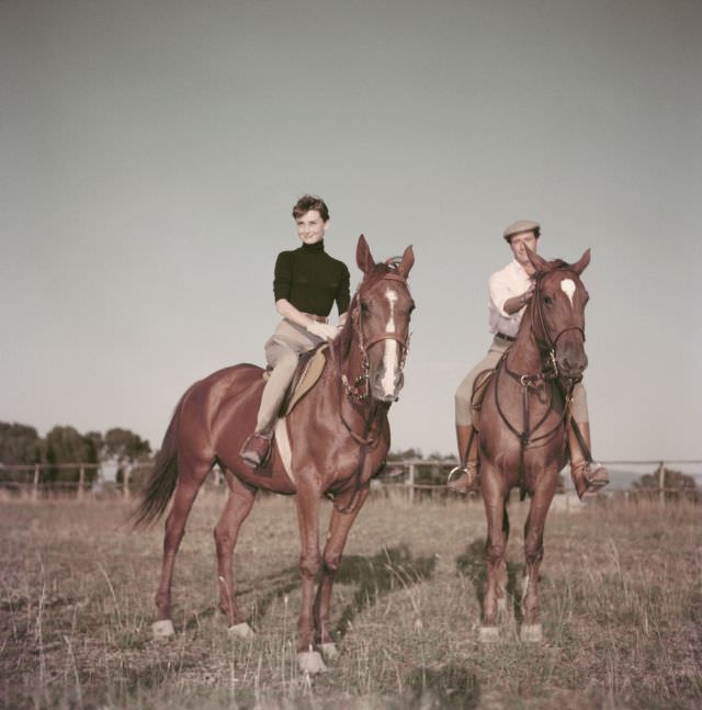 Audrey Hepburn riding horses with husband Mel Ferrer on a farm near Rome, 1955.
