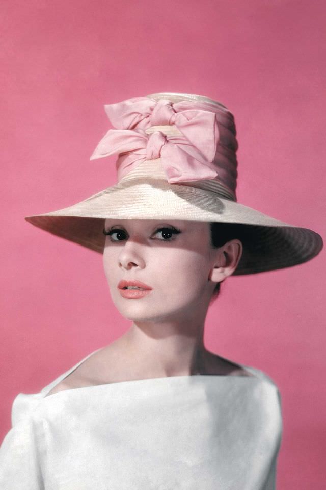 Audrey Hepburn wearing a wide-brimmed hat and white blouse on the set of 'Funny Face,' 1957.