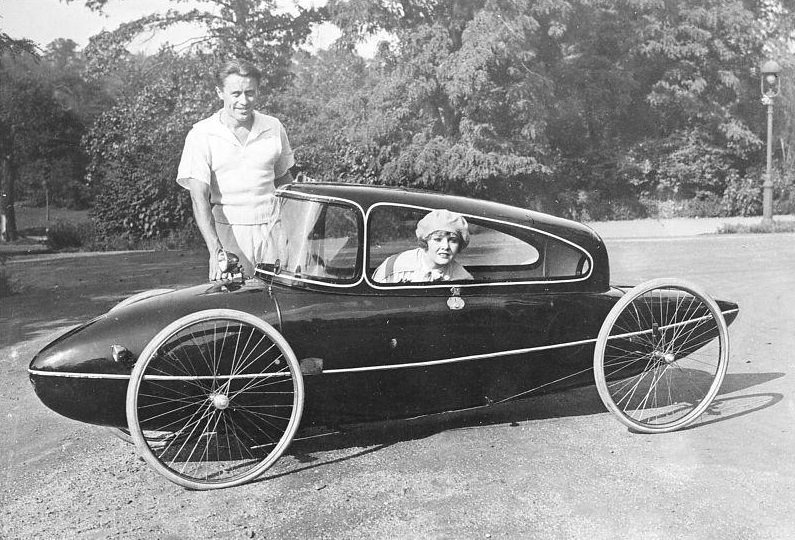 Dr. Manfred Curry standing beside his invention, the Curry-Landskiff, a man-powered vehicle which can reach speed of up to 35 miles per hour.