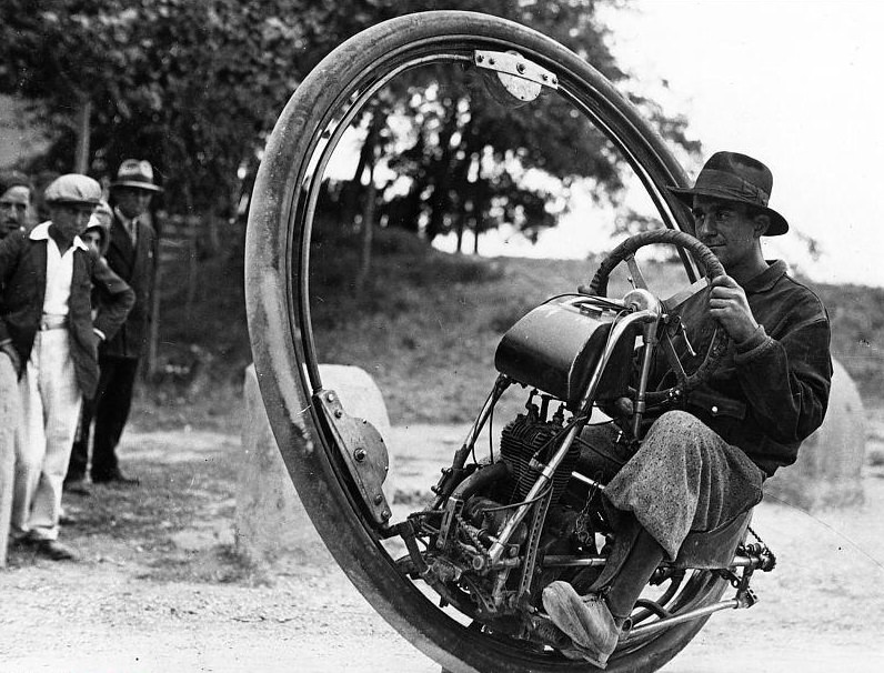 Swiss engineer M. Gerder at Arles , France on his way to Spain in his “Motorwheel”, a motorcycle with a wheel which runs on a rail placed inside a solid rubber tyre.