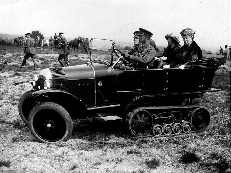 Queen Mary (1867–1953) with Princess Mary, the Princess Royal (1897–1965) being driven across rough ground in a tracked car by Army officers.