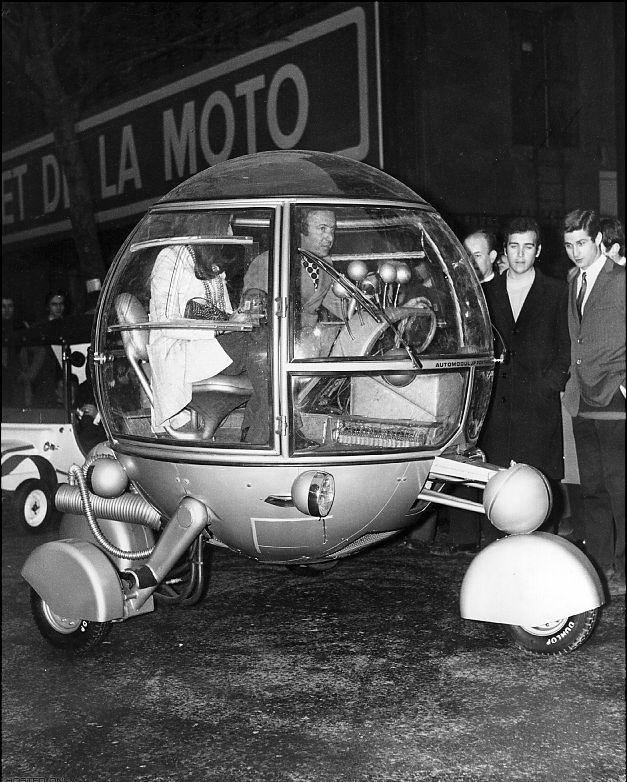 Pussycar Automodul 1968, designer J. P. Ponthieu driving at the the opening of the first Racing Car and Cycle show in Paris.
