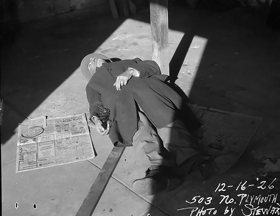 Dead body laying on the ground with gun at side – 1926