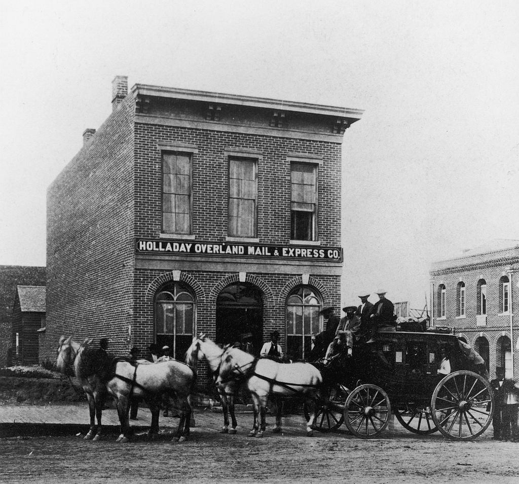 View of a carriage parked outside the Holladay Overland Mail & Express, Denver, 1900.