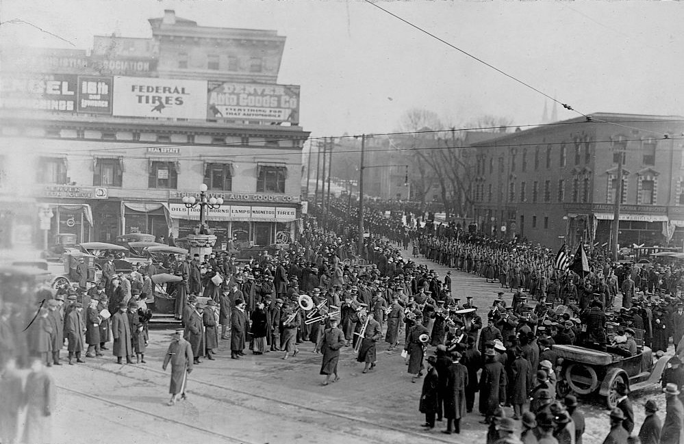 A marching band leads a funeral procession in honor of Buffalo Bill.