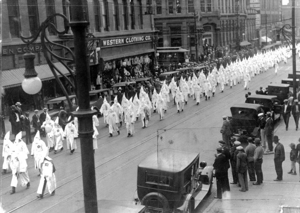 Members of the Ku Klux Klan march in a parade on Larimer Street in Denver, 1910s