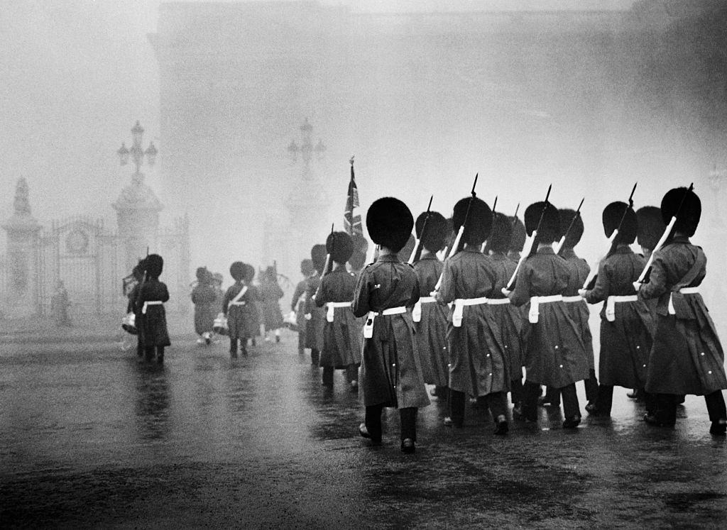 Scots Guards march towards Buckingham Palace to take up sentry duty during the Great Smog of 1952.