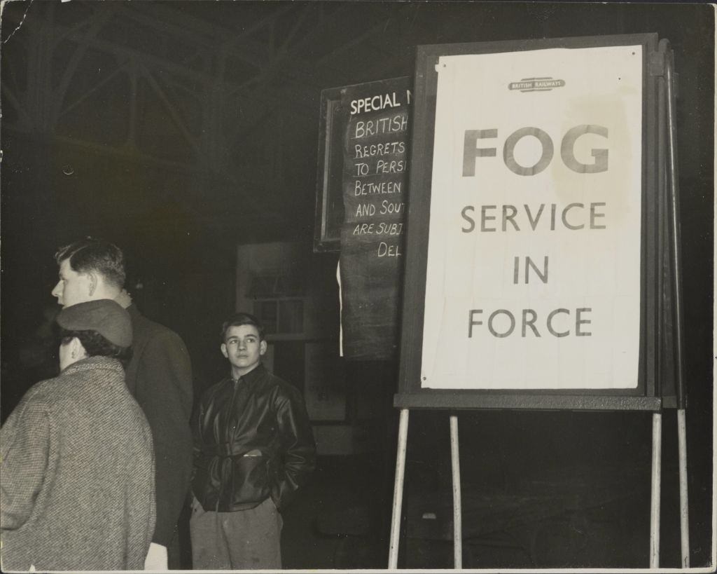 The Fog Service in Force notice at Paddington Station, London, 1952.