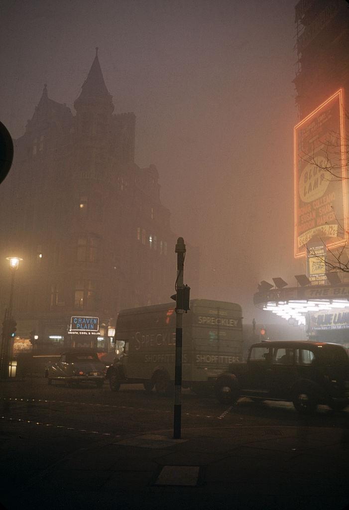 Street scene on a foggy night near the Palace Theatre in Cambridge Circus, London, 1952.