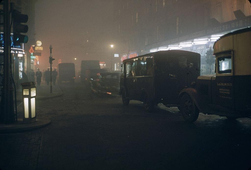 Street scene on a foggy night near the Palace Theatre in Cambridge Circus, London, England, 1952.