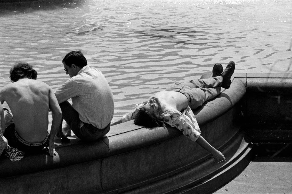 A man relaxes in the sunshine in Trafalgar Square, London during the heatwave.