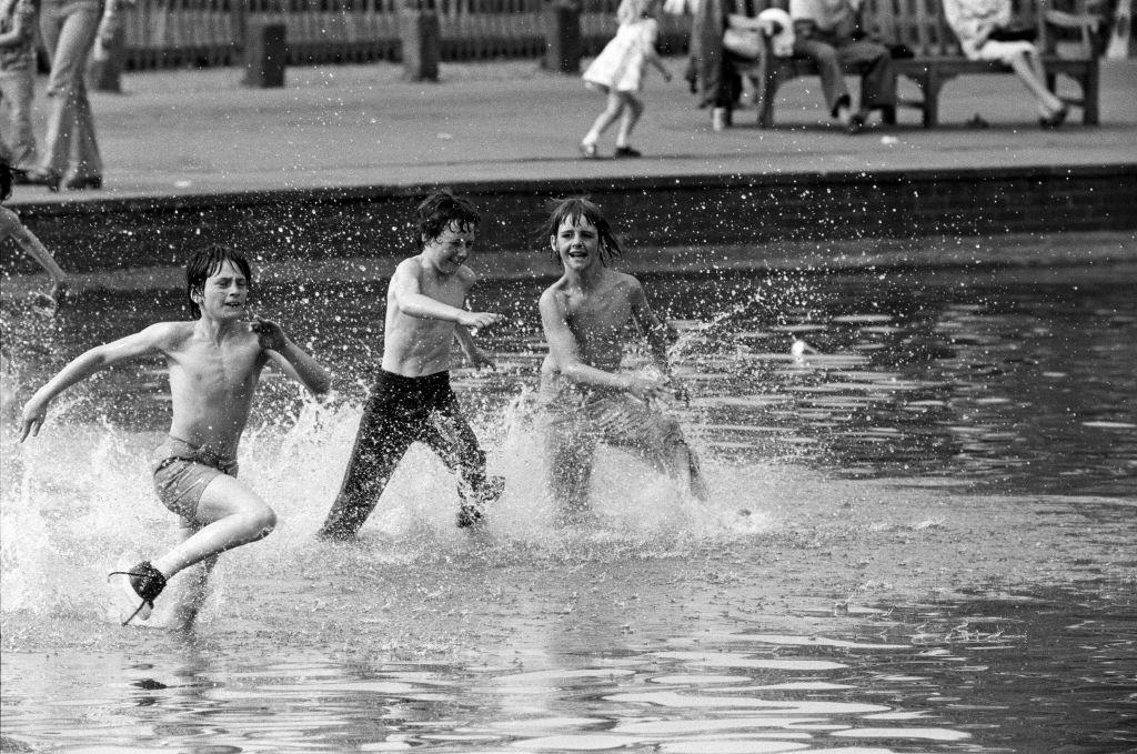 Today's sun brought out people onto Hampstead Heath to cool off in the water, 8th May 1976.