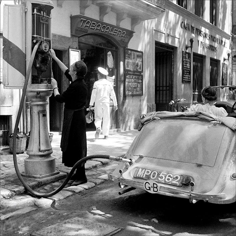 Woman refilling at a petrol station, 1956