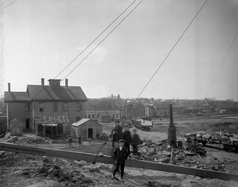 Young boys in foreground posing for camera at Willis Point. Railroad in background, 1907