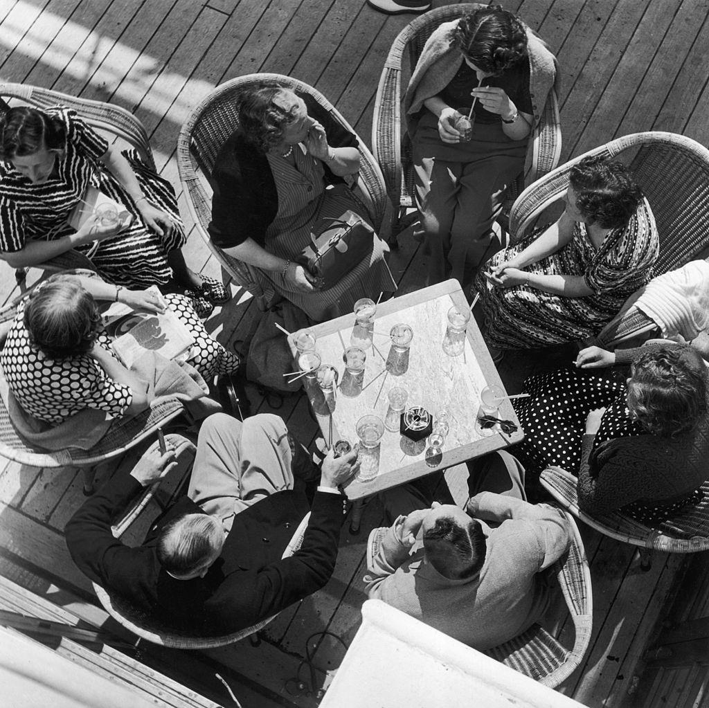 Holidaymakers sip cocktails aboard the SS Chusan cruise liner off the coast of Norway, July 1951.