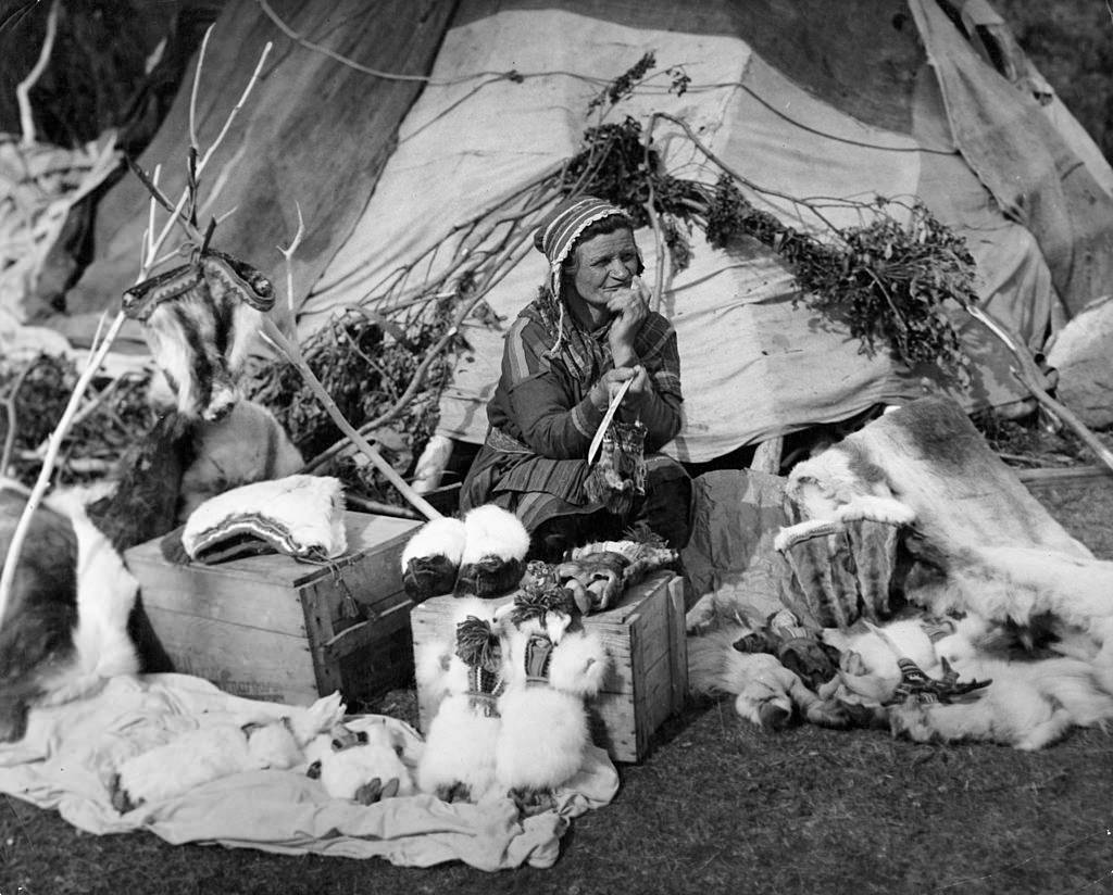 An old Lapp Woman displays wares in Lyngseidet, Norway, 1955.
