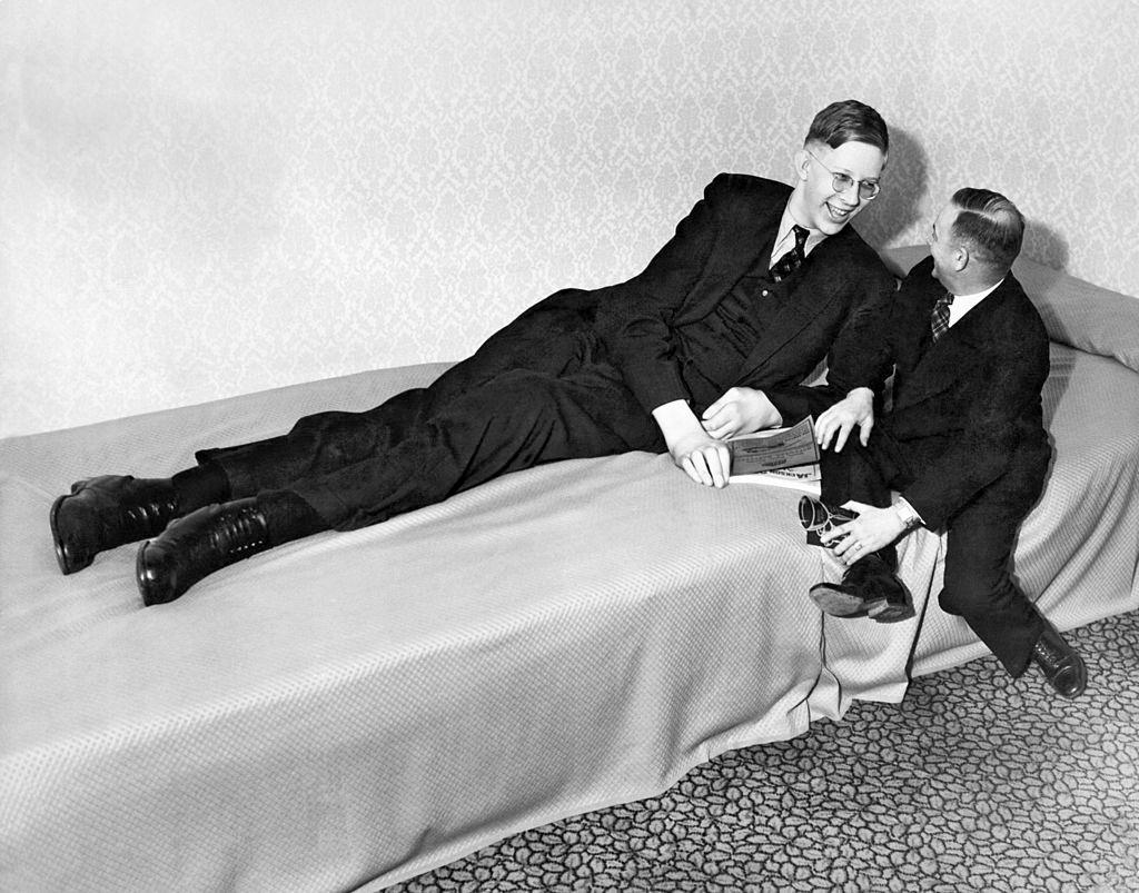 Nineteen year old Robert Wadlow of Alton, Illinois, chatting with a friend after appearing at a charity event, Omaha, Nebraska.