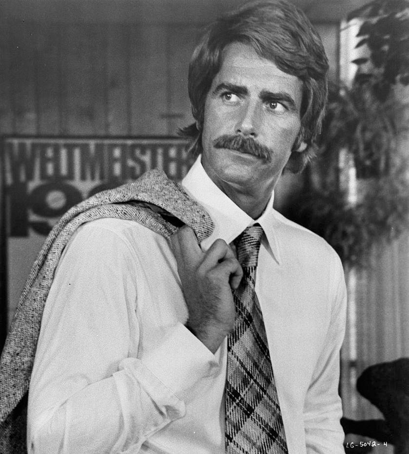 Sam Elliott with coat over shoulder, 1976.