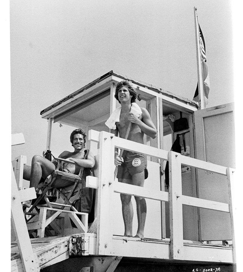 Sam Elliott and Parker Stevenson on lifeguard tower in a scene from the film 'Lifeguard', 1976.