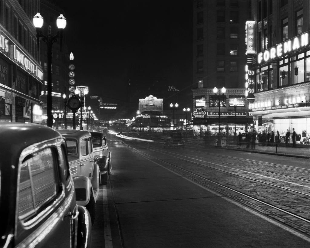 Neon sign and parked cars along 4th Avenue Seattle, 1934.