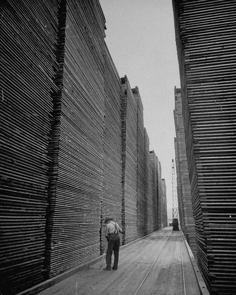 Man sweeping the lumberyard of Seattle, 1939.