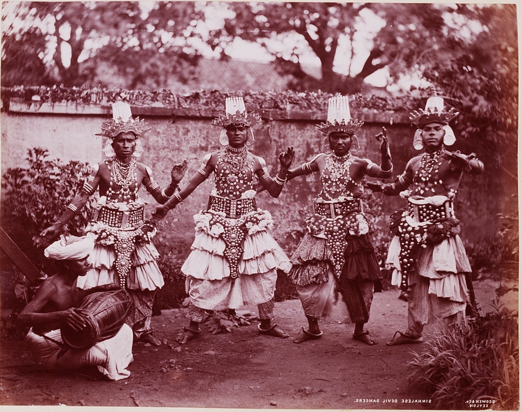 Four male Singhalese dancers in traditional costum, Sri Lanka, 1880s.