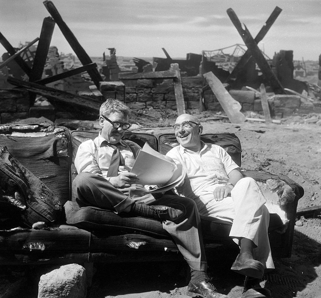 Actor Burgess Meredith talking to director John Brahm in between scenes of "Time Enough at Last", episode 8, 'The Twilight Zone', August 1959.