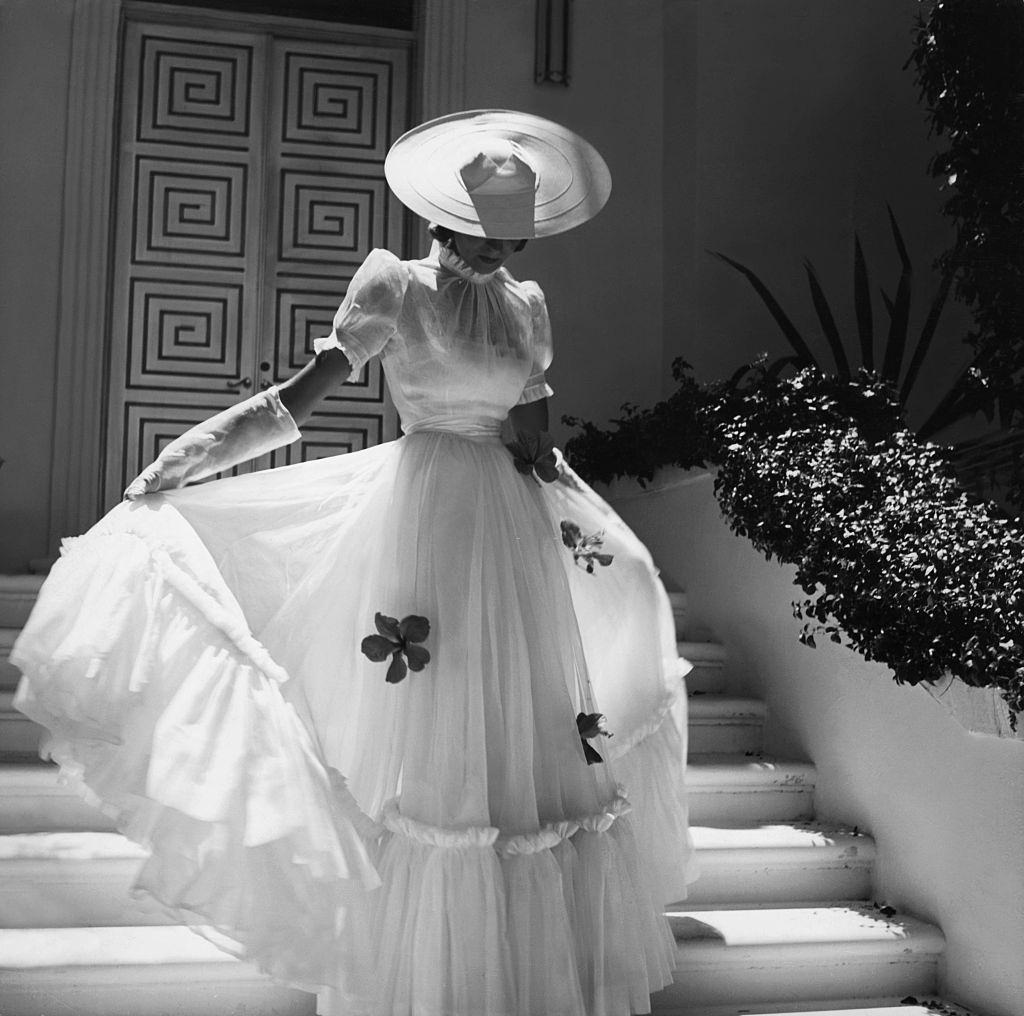 Model, wearing a filmy, white organdy dress, 1938.