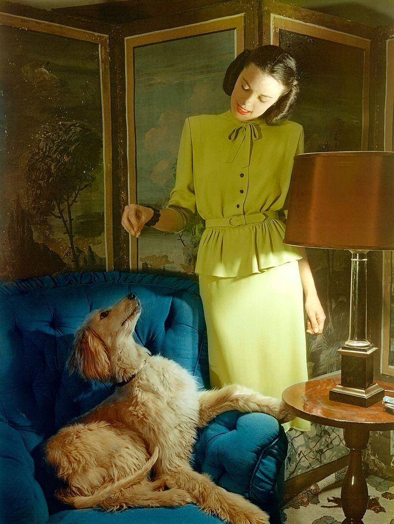 Model in lime green suit in rayon crepe with tiny jet buttons, Glamour 1944.
