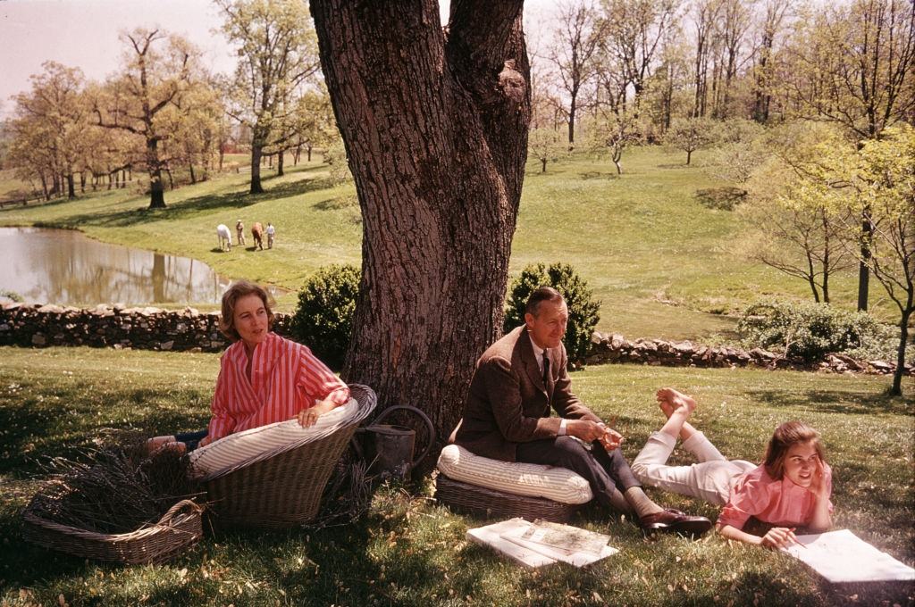 American philanthropists and art collectors Paul Mellon and Rachel 'Bunny' Lambert Mellon lounging with one of their children, 1963.