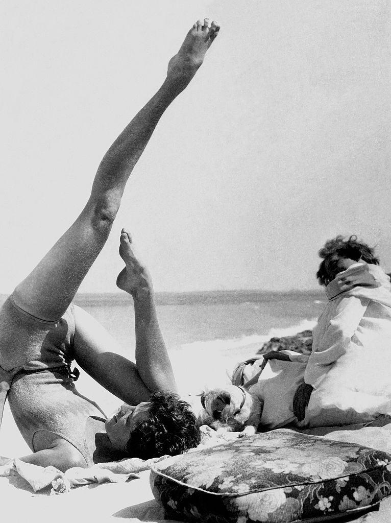 Mrs. Francis McNeil Bacon III, doing yoga on a beach.