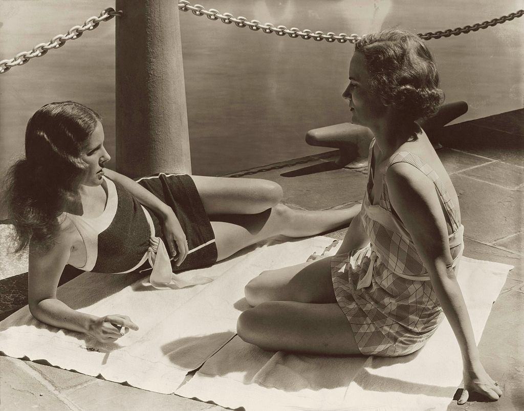 Mrs. Warren Leslie Jr. and Mrs. George G. Bourne lounging in their swimsuits at the River Club.