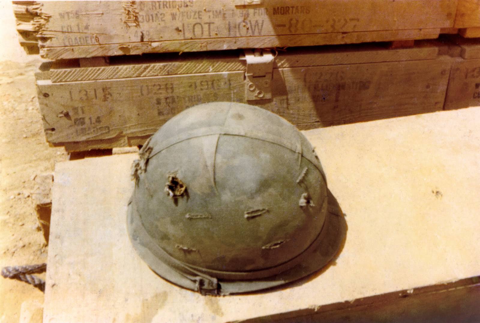 The photographer’s helmet, with two bullet holes. Fire Base L.Z. Stinson, Quang Ngai Province, Vietnam.