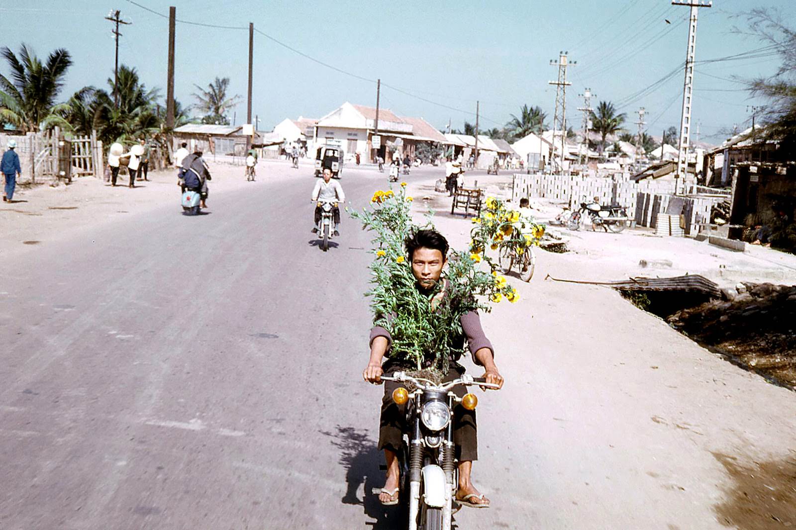 A Vietnamese man with marigolds. Qui Nhon, Vietnam.