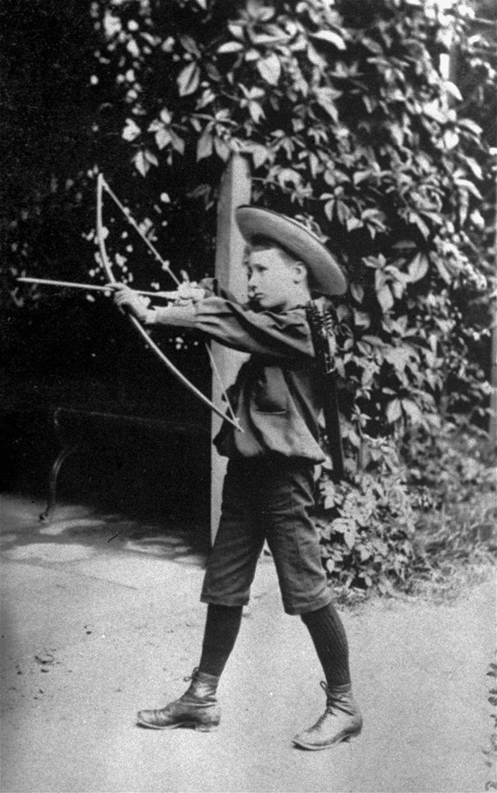 Franklin Delano Roosevelt playing with a bow and arrow circa 1890.