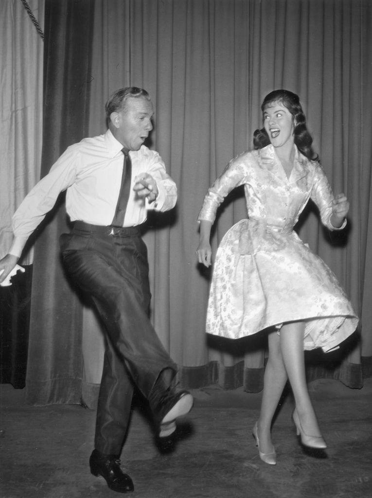 Ann-Margret showing her dance step to American comedian George Burns, 1955.