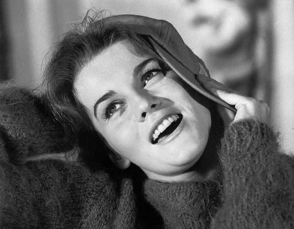 Ann-Margret holding Cap to her head, 1962.