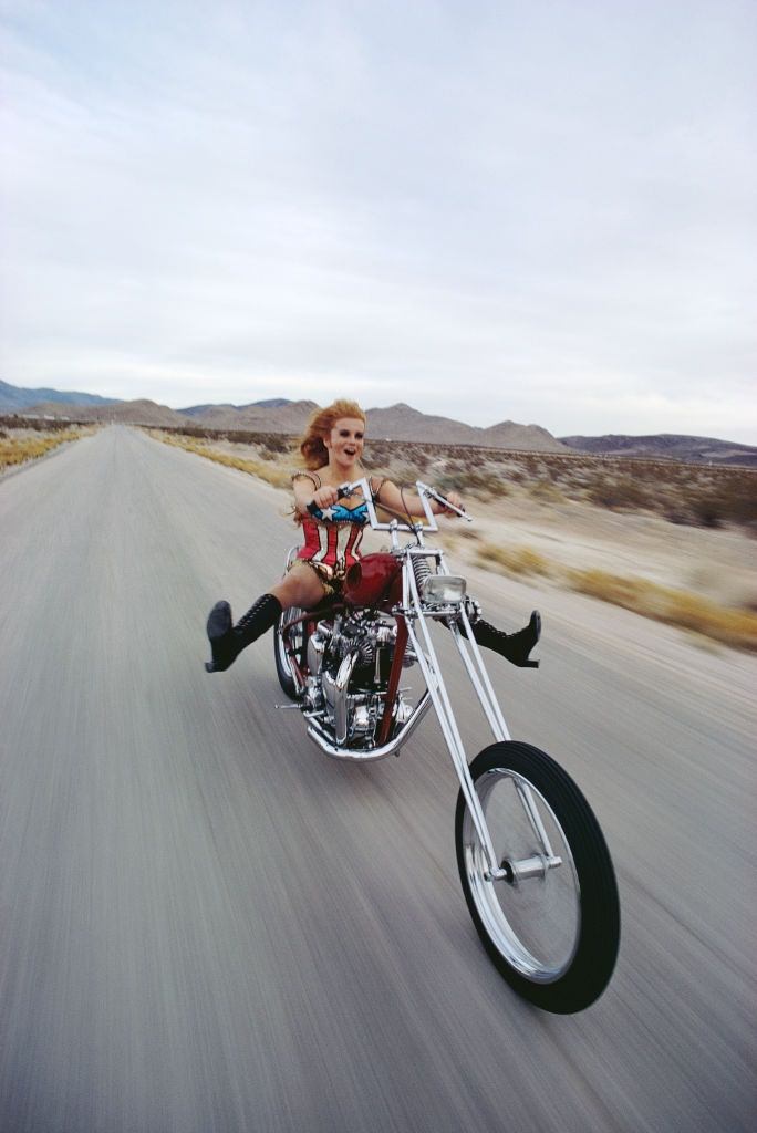 Ann-Margret rides a chopper motorcycle in the desert outside Las Vega, 1969.