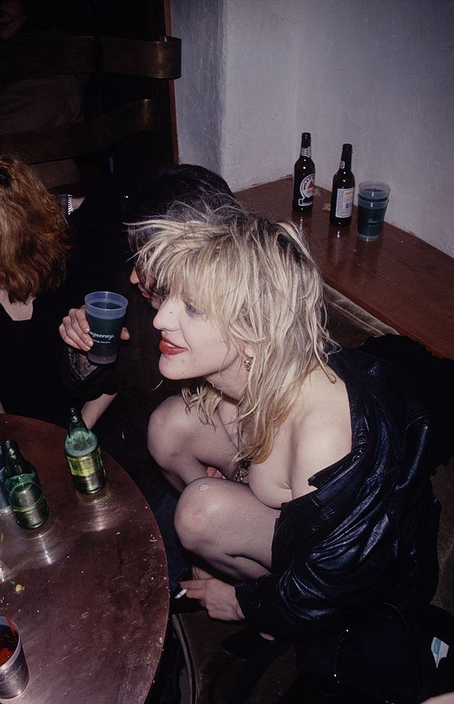 Courtney Love enjoying a drink and smoking, 1993.