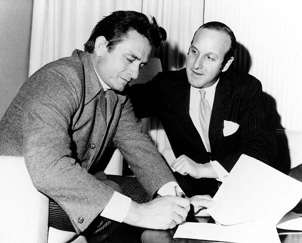 Johnny Cash signing a contract with Columbia Records lawyer Clive Davis in circa 1960.