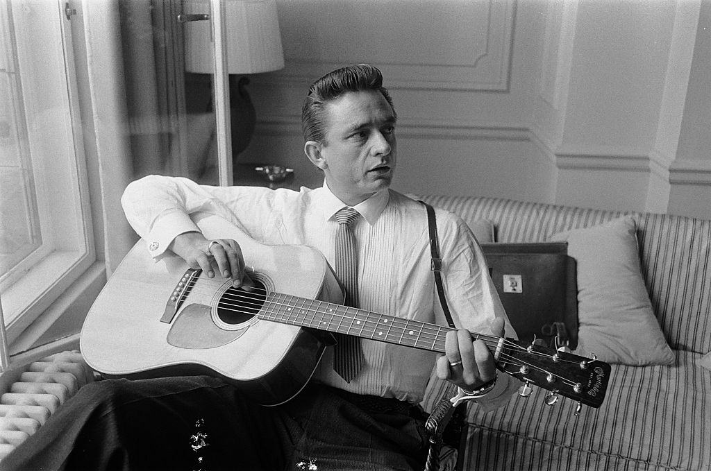 Johnny Cash playing guitar at the Savoy Hotel in London, September 1959.