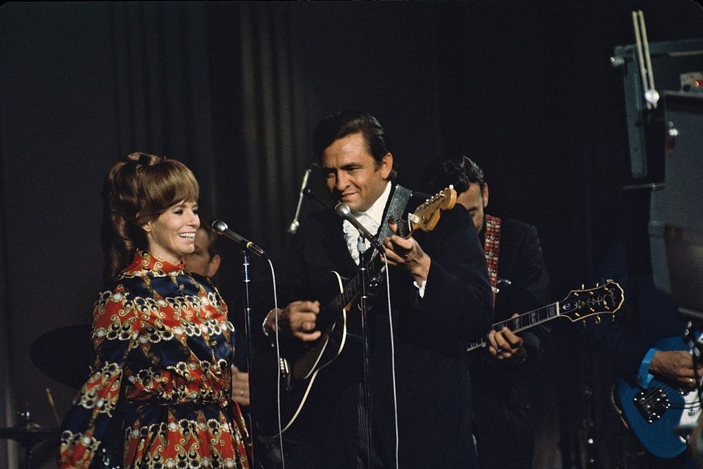 Johnny Cash with his wife June Carter peforming on the stage, 1969.