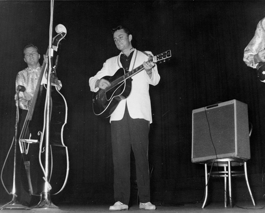 Johnny Cash performs onstage with his backing band "The Tennessee Two", 1956.