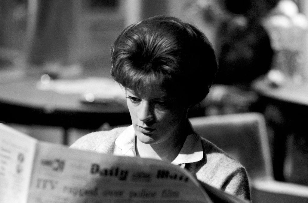 Maggie Smith as Sarah Watkins reads the Daily Mail while on the set of the film 'The Honey Pot' circa 1967